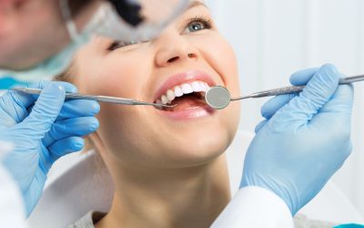 Dental health. Male hygienist examining patient teeth on caries